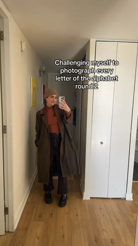 A mirror selfie with the text challenging myself to photograph every letter of the alphabet
